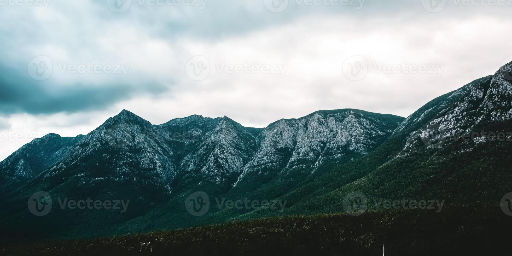 Majestic mountain range under a cloudy sky photo