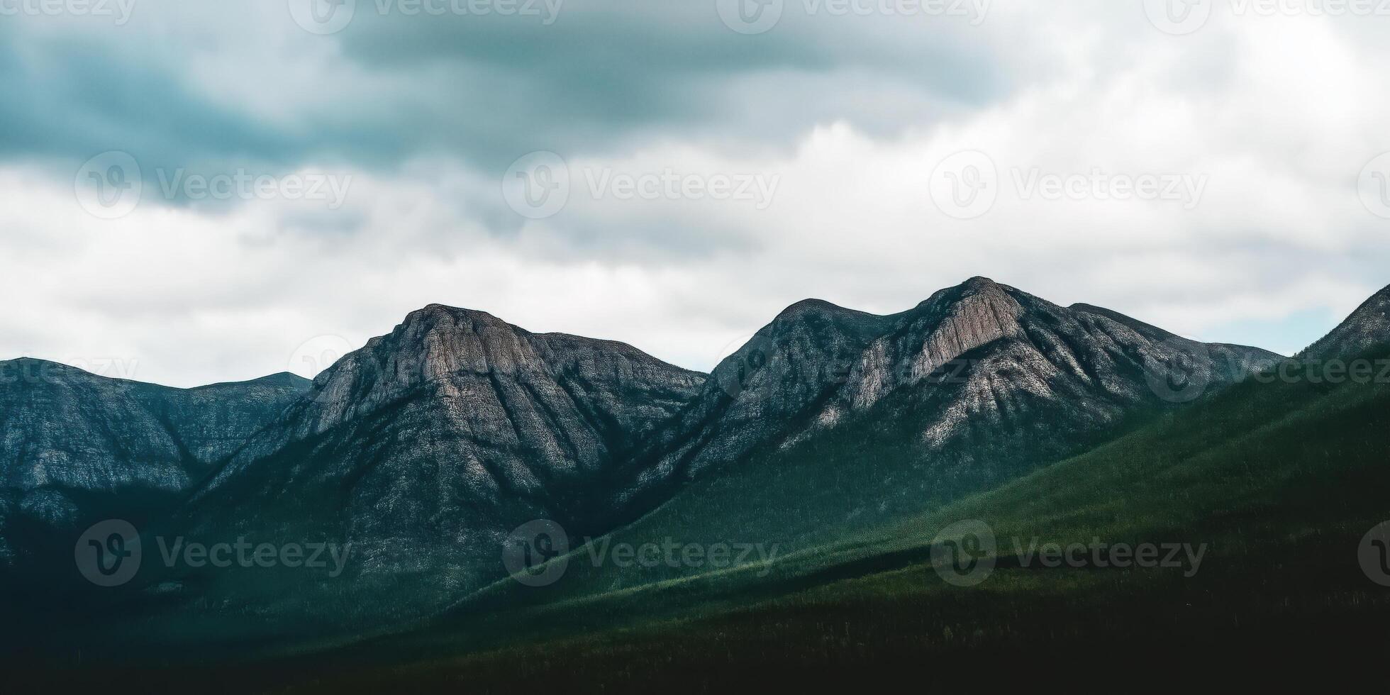 Majestic mountain range under cloudy sky photo