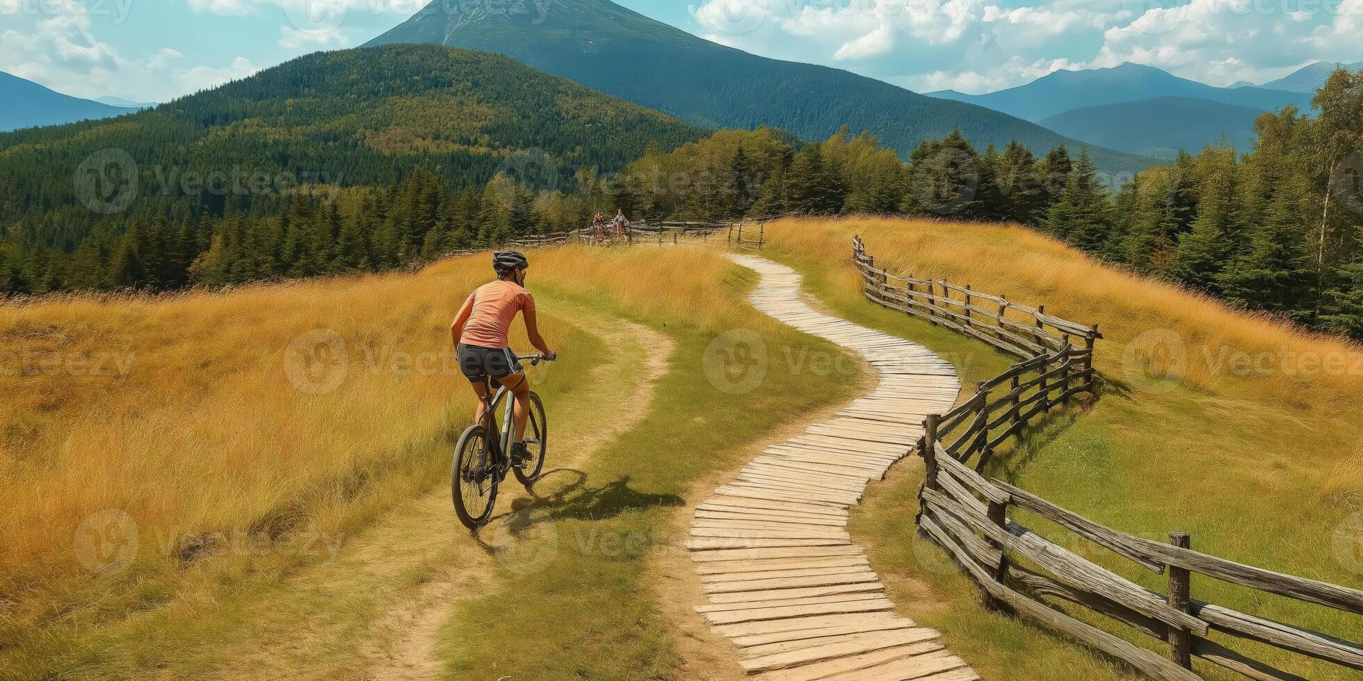 A man riding a bike on a path in the mountains photo
