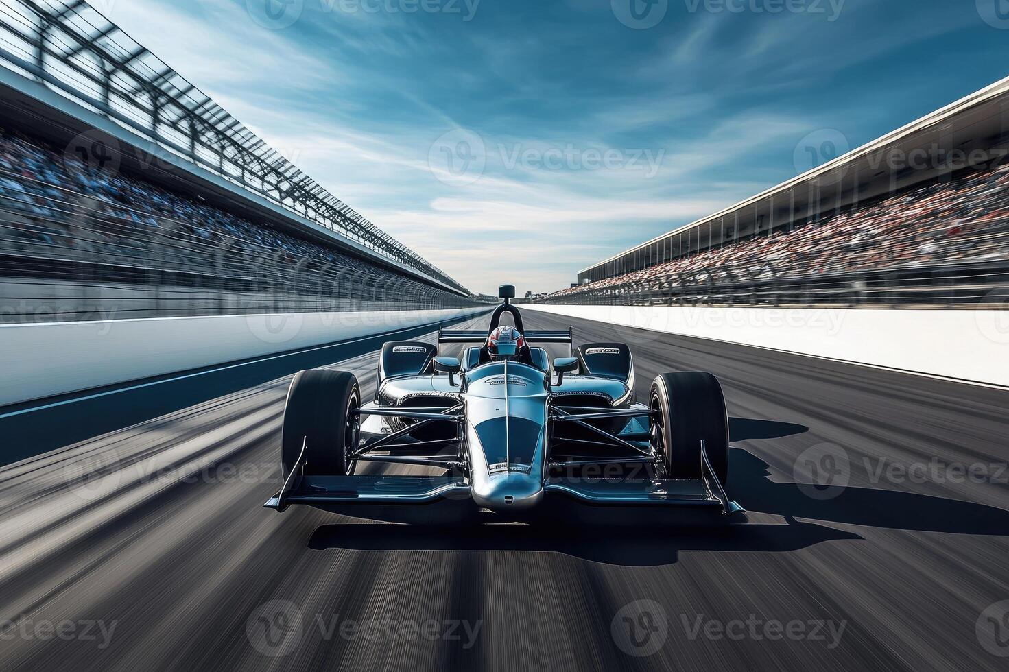 Racecar driver driving on a racetrack with blurred spectators photo