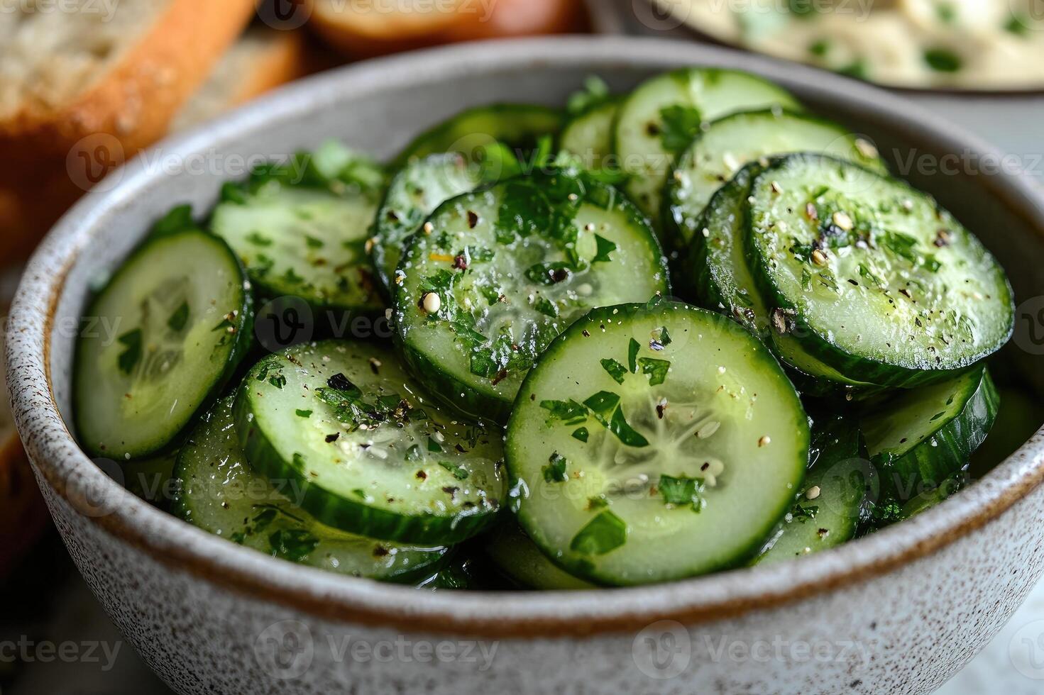 Refreshing cucumber salad with parsley and spices in a bowl photo
