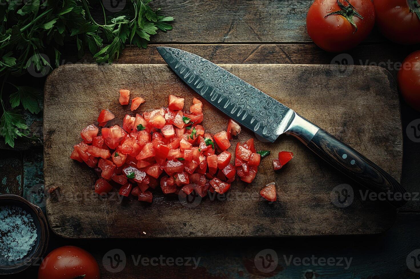 Chef chopping fresh tomatoes and parsley on wooden cutting board photo