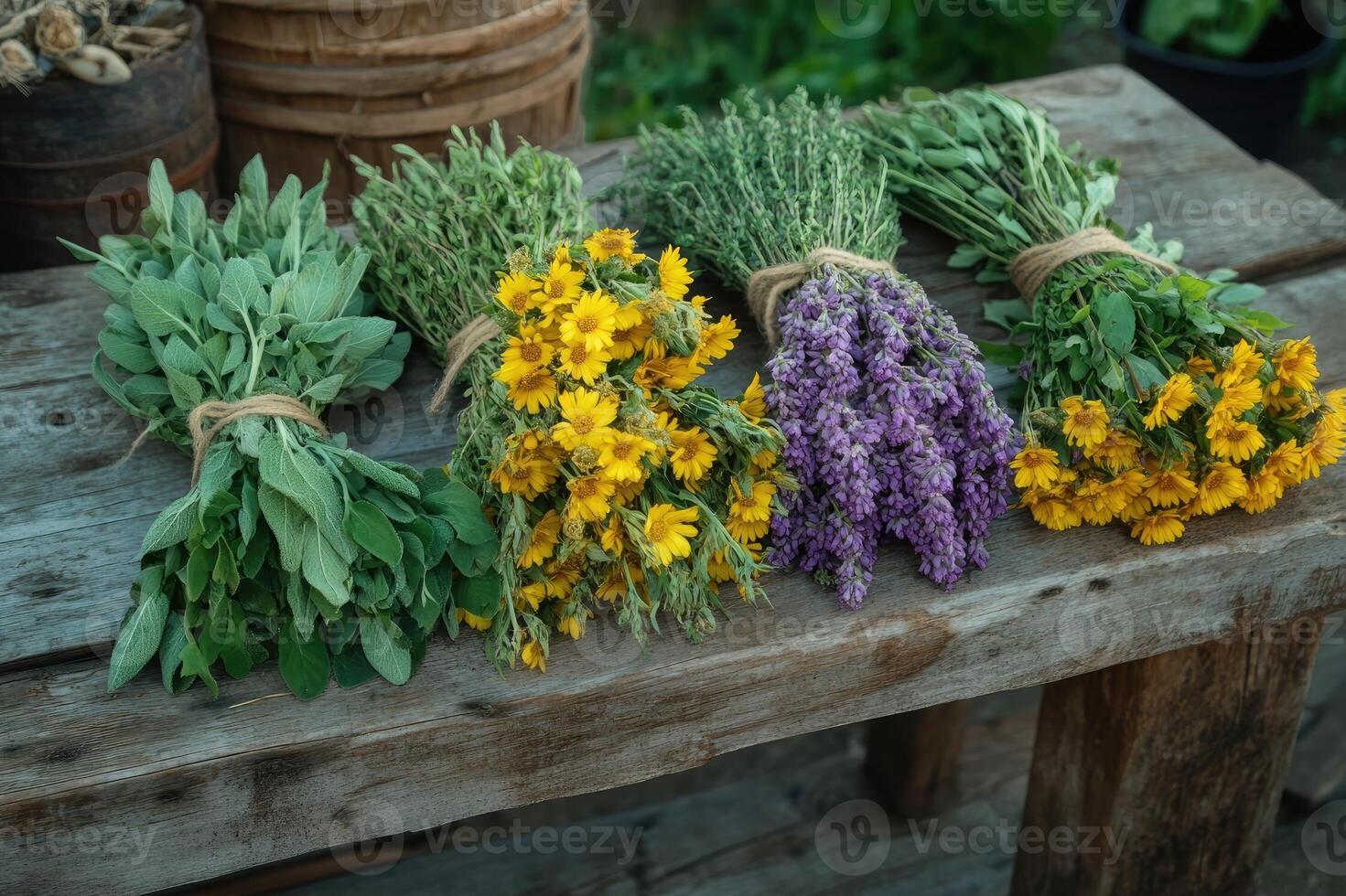 Freshly harvested herbs and flowers drying on rustic wooden table photo