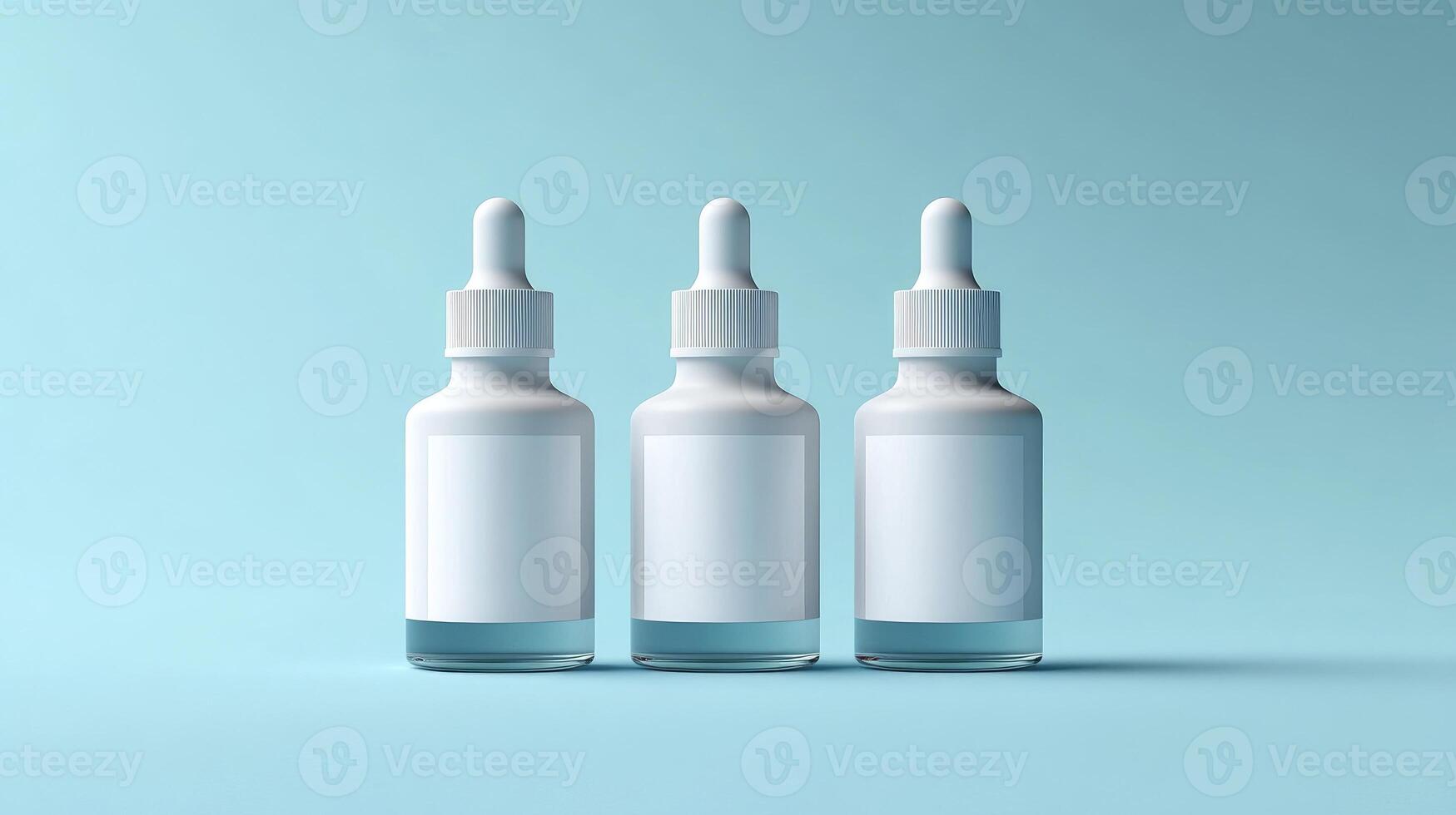 Three transparent dropper bottles with blank white labels on a pastel blue background photo