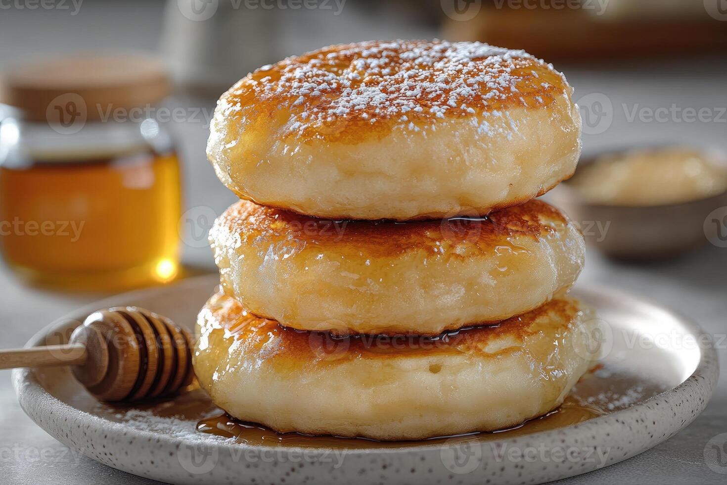 Stack of fluffy pancakes dripping with honey and icing sugar for a sweet breakfast photo