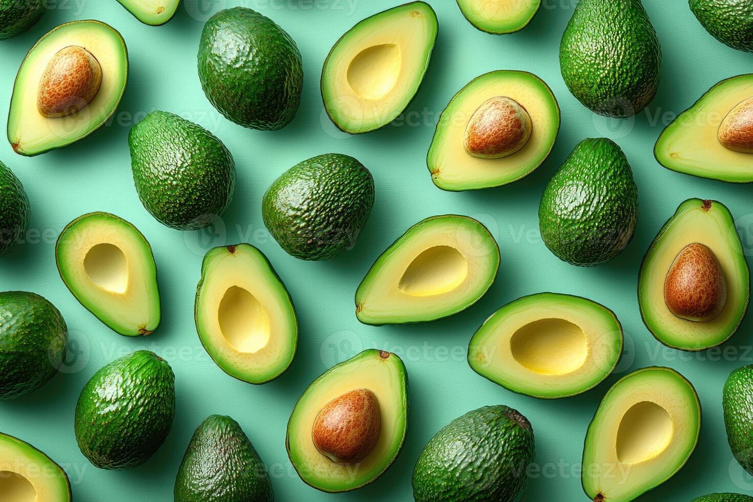 Fresh avocados whole and halved creating a vibrant green pattern photo