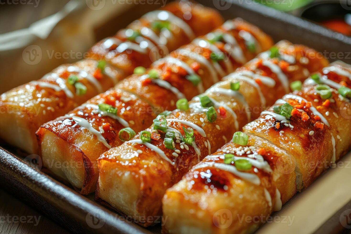 Crispy spring rolls topped with sesame seeds and mayonnaise drizzle photo