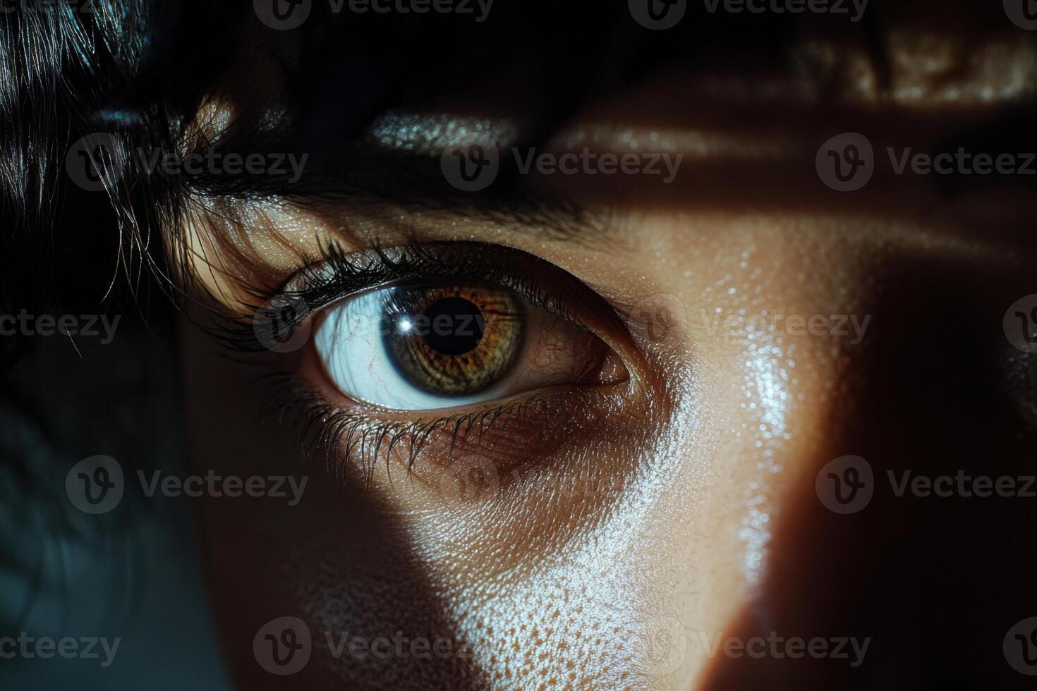 Close-up of a person's eye capturing light and shadow in a dramatic setting during the evening photo