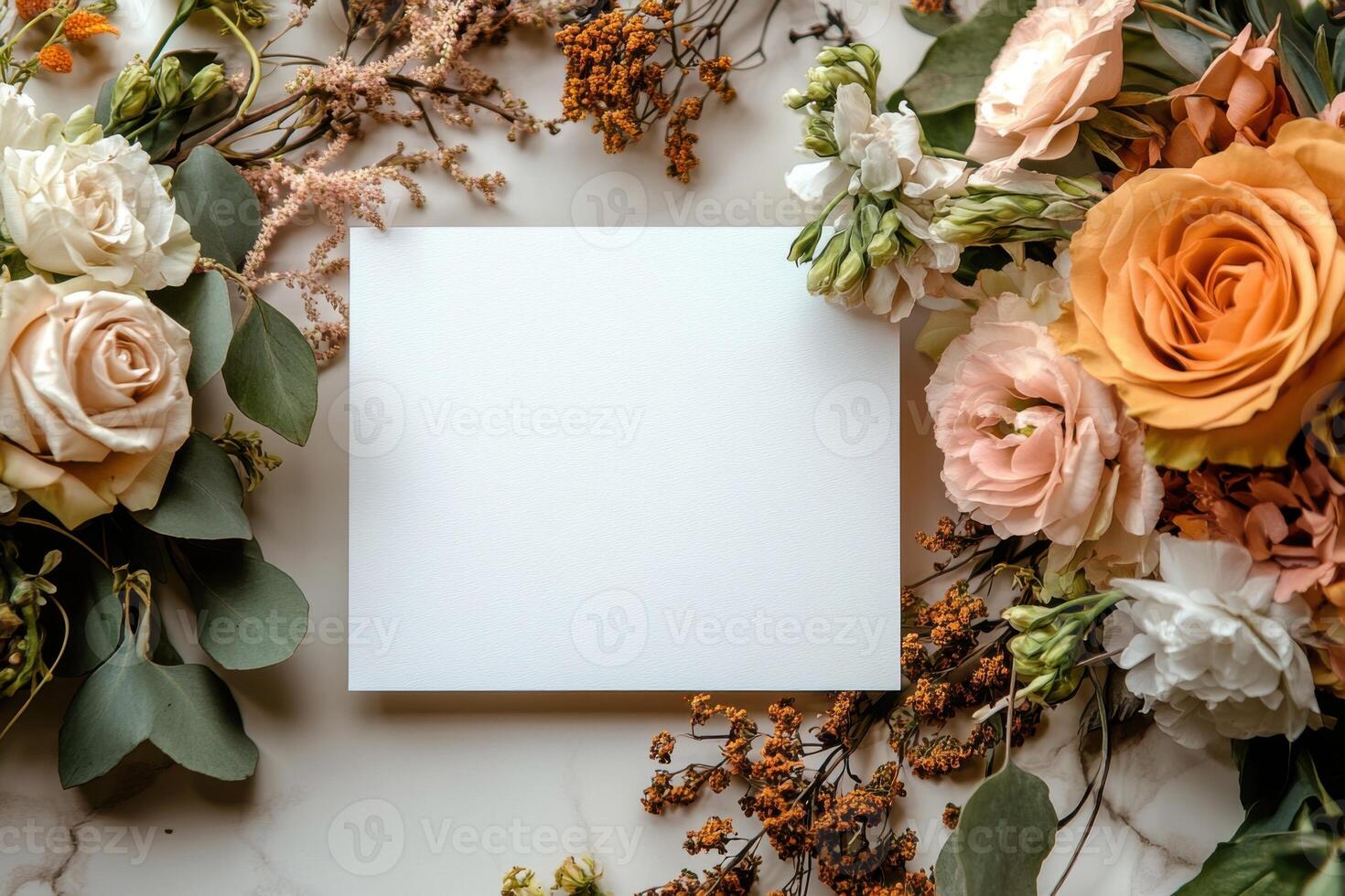 Elegant arrangement of flowers surrounding a blank card for personal messages and invitations photo