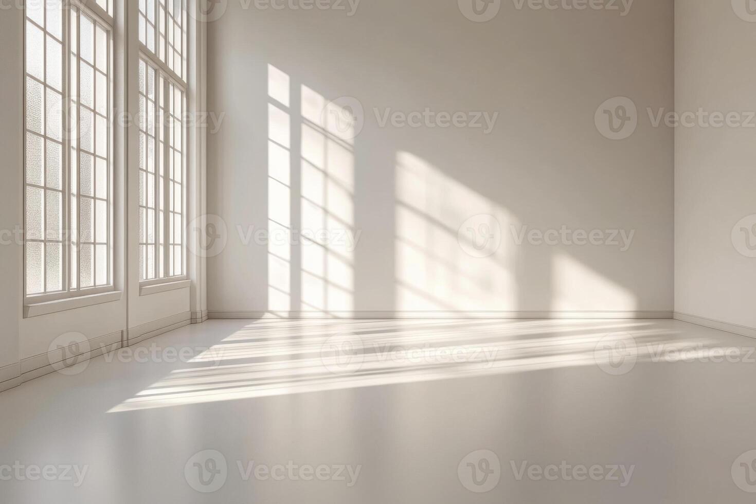 Bright empty room with sunlight streaming through large windows creating soft shadows on the floor photo
