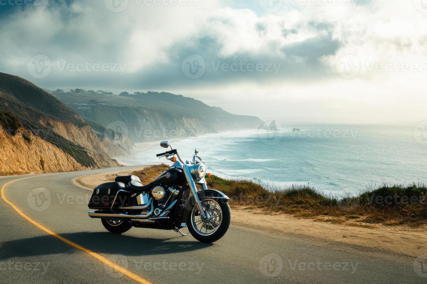 Scenic coastal highway with a classic motorcycle parked overlooking the ocean at sunset photo
