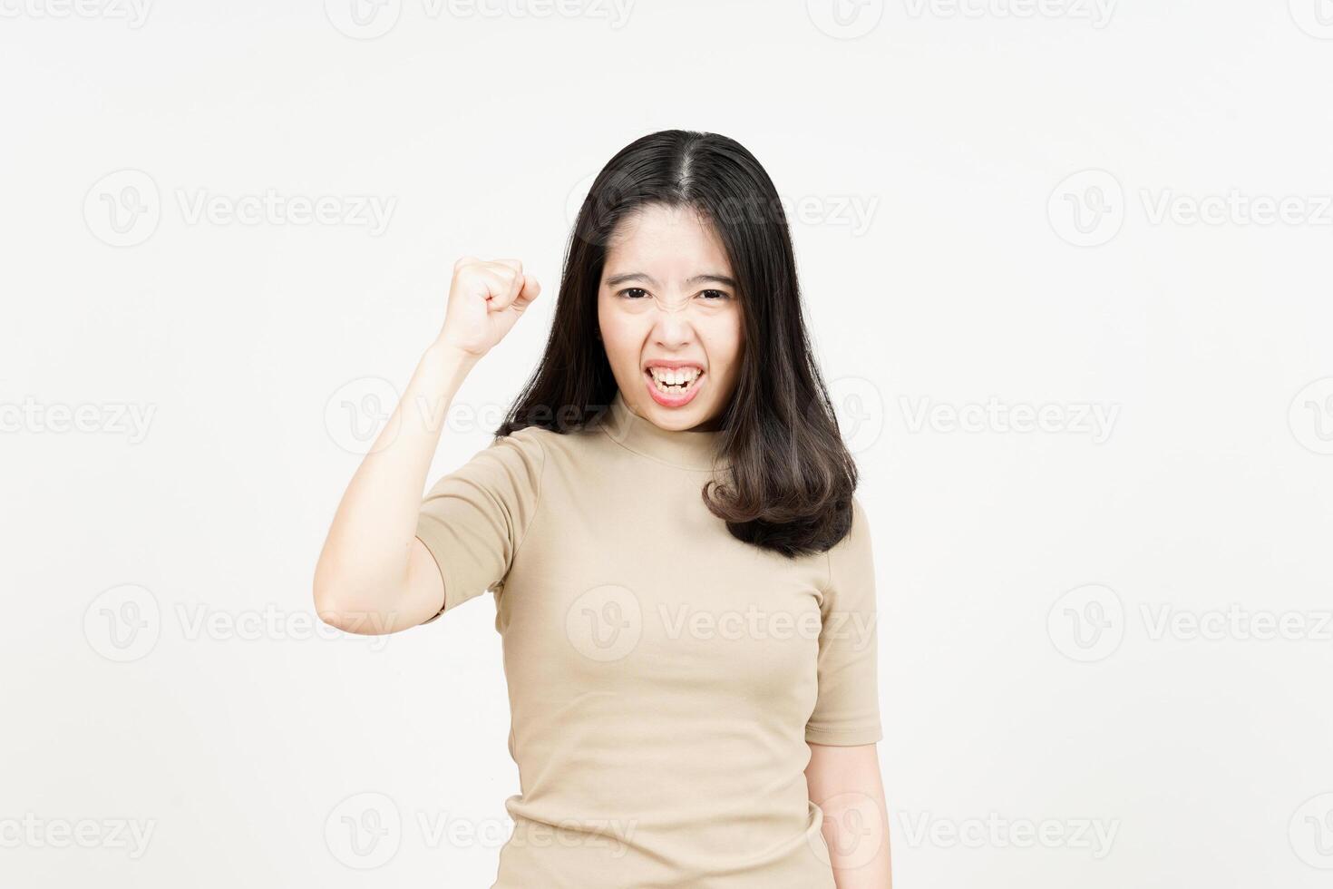 Angry asian woman with fist raised against white background photo