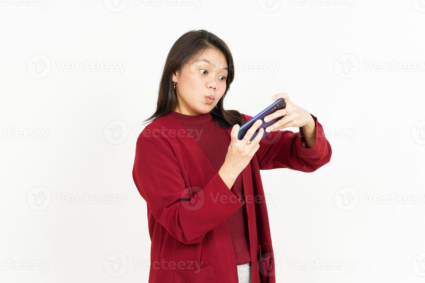 Playing Mobile Game on Smartphone Of Beautiful Asian Woman Wearing Red Shirt Isolated On White photo