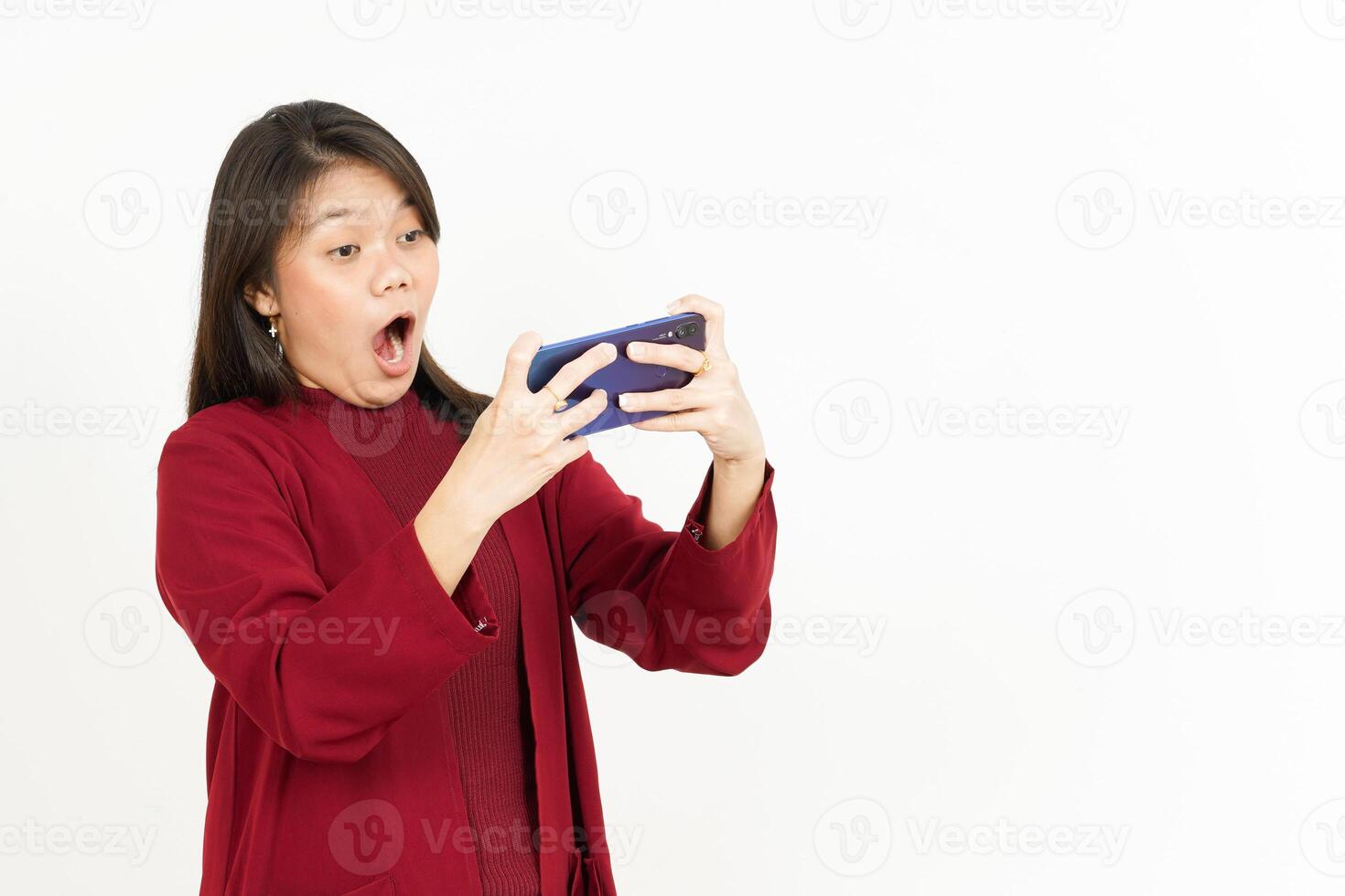 Playing Mobile Game on Smartphone Of Beautiful Asian Woman Wearing Red Shirt Isolated On White photo