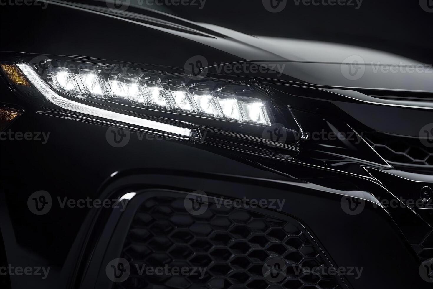 A close-up view highlights the stylish design of a black vehicle, emphasizing its striking LED lights against a dark backdrop. The sleek contours create an impression of speed and sophistication. photo