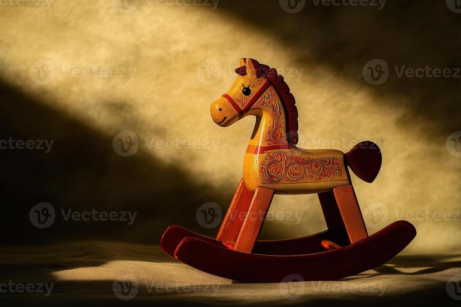 A charming wooden rocking horse is illuminated by soft, warm light casting gentle shadows. This nostalgic toy adds a playful touch to a childs room, inviting imagination and joy. photo