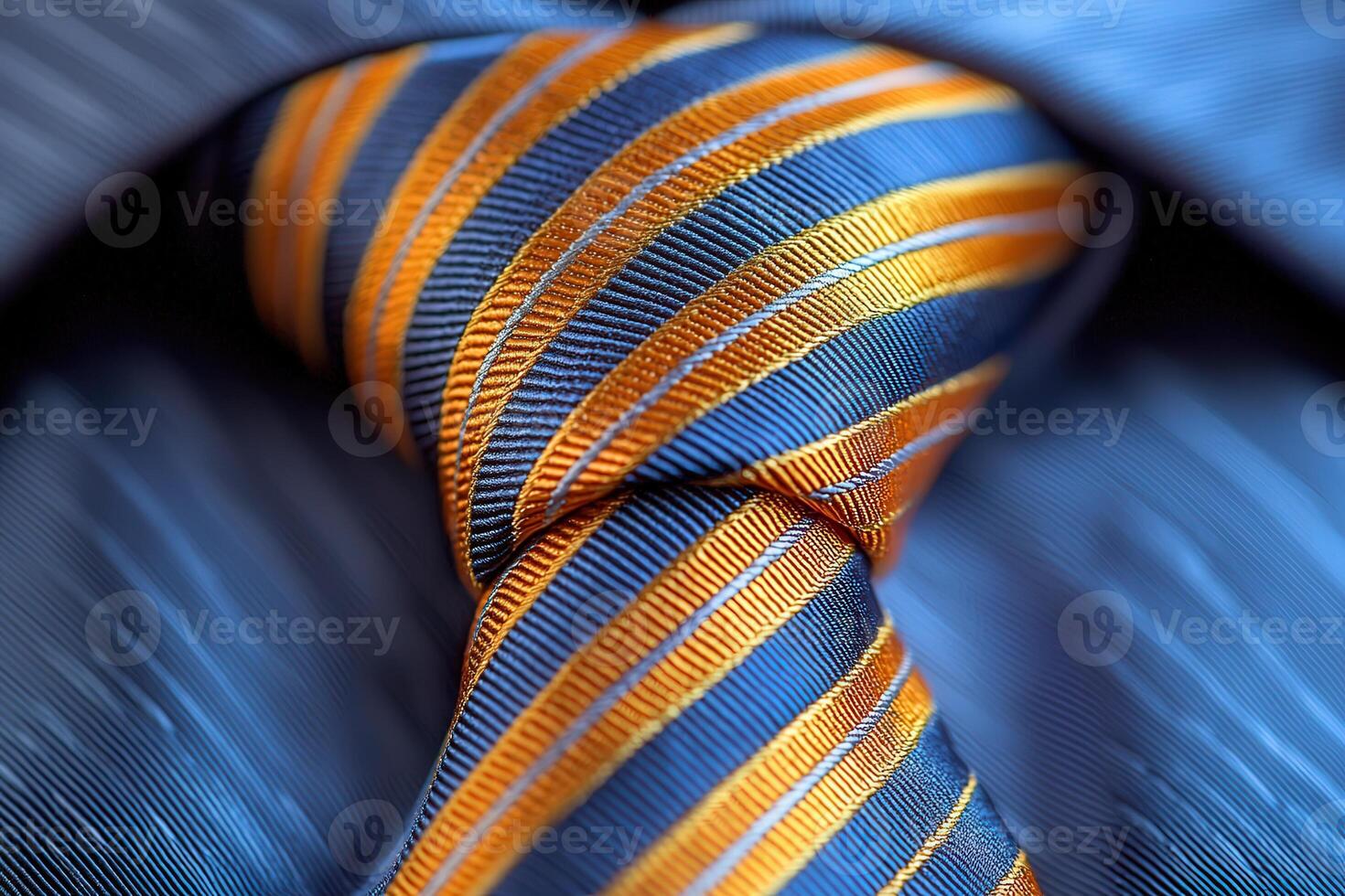 A close up view of a neatly knotted tie featuring vibrant orange and blue stripes, set against a formal shirt. The fabric texture and colors create a sophisticated appearance. photo