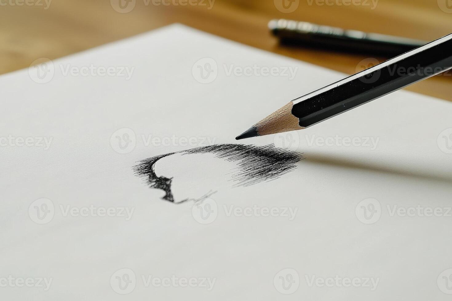 A close-up view of a pencil creating a detailed sketch on white paper. The workspace is simple, highlighting the artistic process in a calm environment. photo