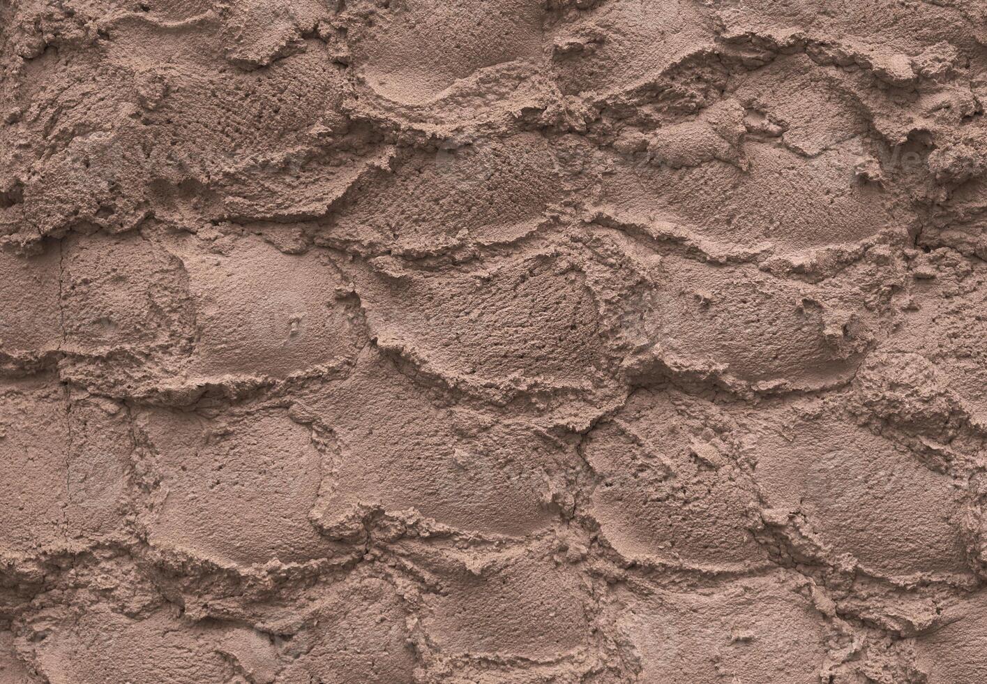 Ice cream texture. Appetizing and delicious background of chocolate ice cream arranged in hemispheres. Textured background of a wall made of plaster. Mocha Mousse, Color of the Year 2025. photo