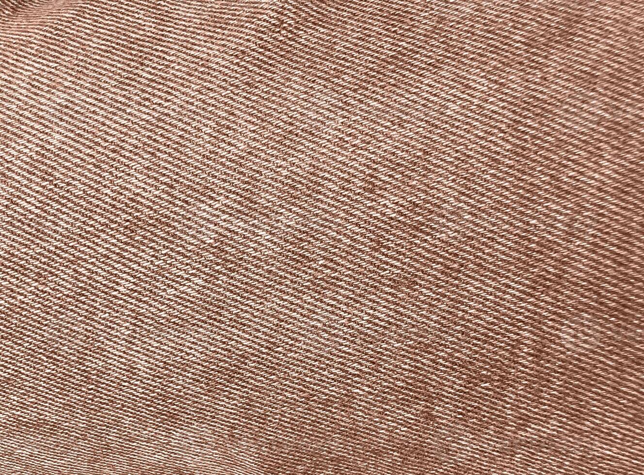 Rich mocha-toned denim jeans textile for any background. Faded fabric jeans. Denim Material. Canvas denim jeans texture. Mocha Mousse Color of the Year 2025. photo