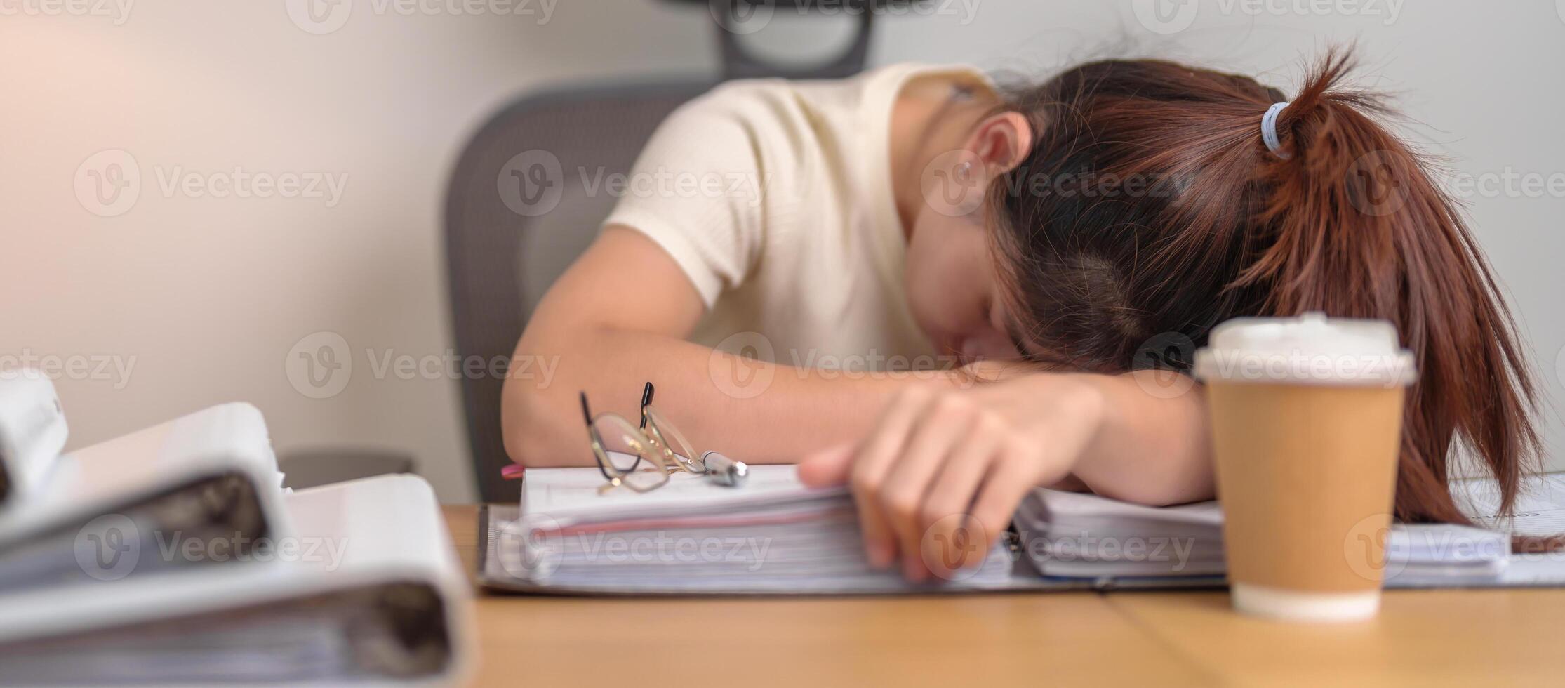 Stressed Asian woman having Tired and Sleepy while working, female businesswoman having headache at office, Exhausted woman with documents folder stack at home late night. Overworked and Overtime photo