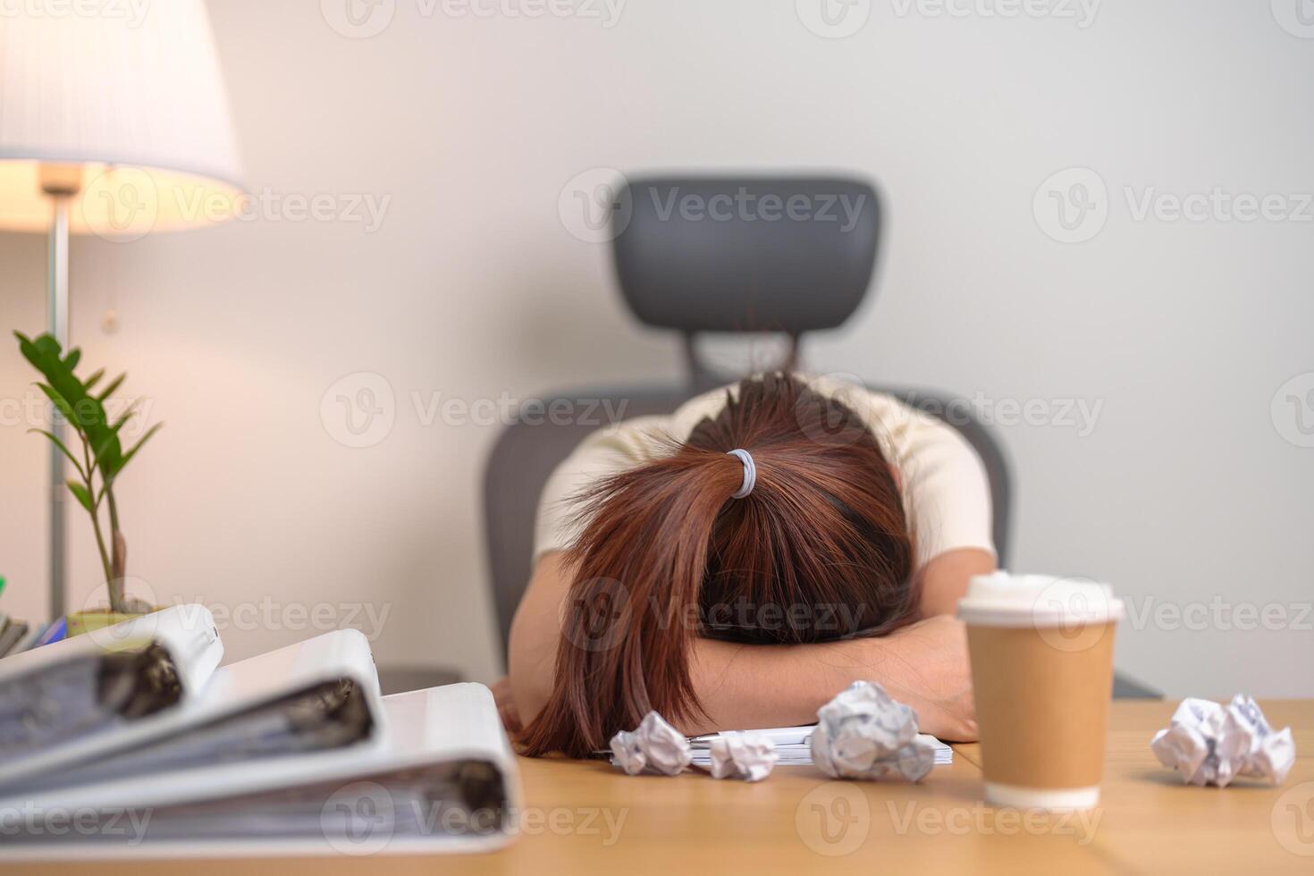 Stressed Asian woman having Tired and Sleepy while working, female businesswoman having headache at office, Exhausted woman with documents folder stack at home late night. Overworked and Overtime photo