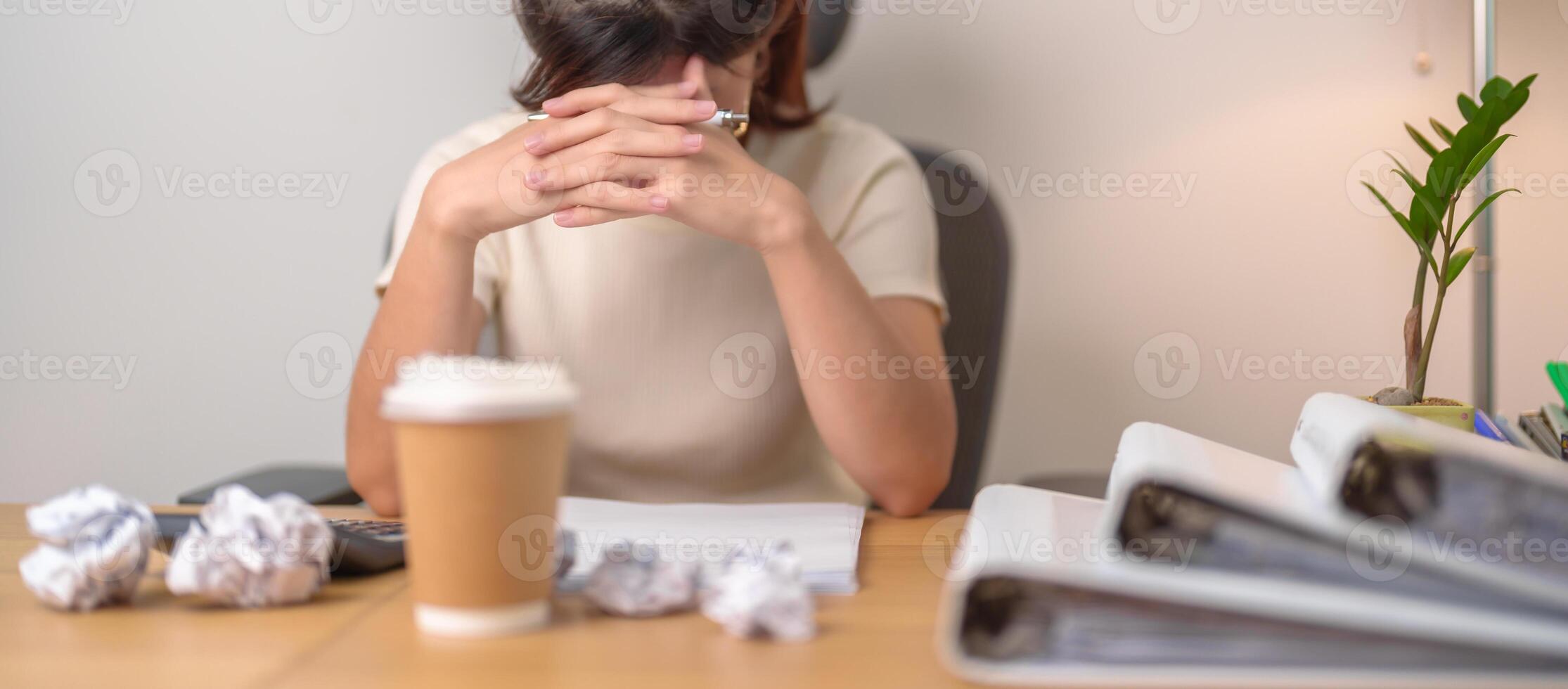 Asian woman having Tired and Stressed while working, female businesswoman having headache and Migraine at office, Exhausted woman with document folder stack at home late night. Overworked and Overtime photo