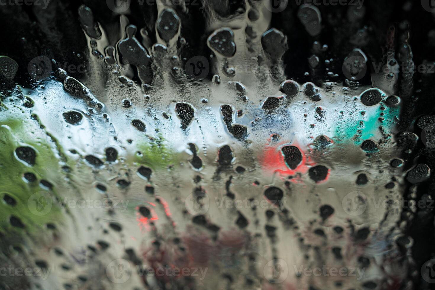 Soap sud wave pattern on car windshield photo