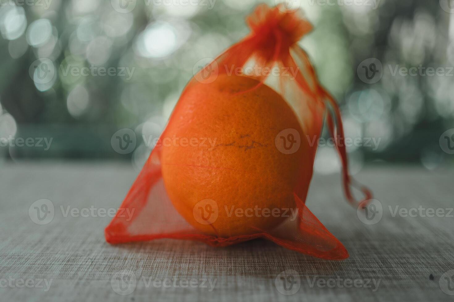 Oranges in a red mesh bag. Concept of traditional Chinese new year lucky fruit photo