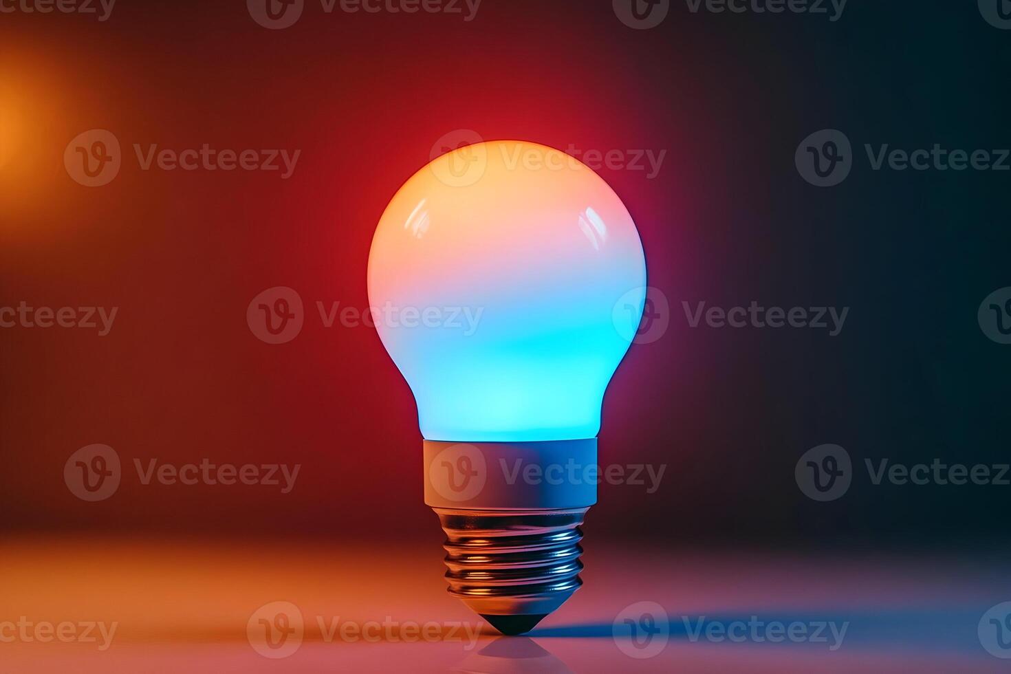 Illuminated lightbulb with red and blue glow on dark background. photo
