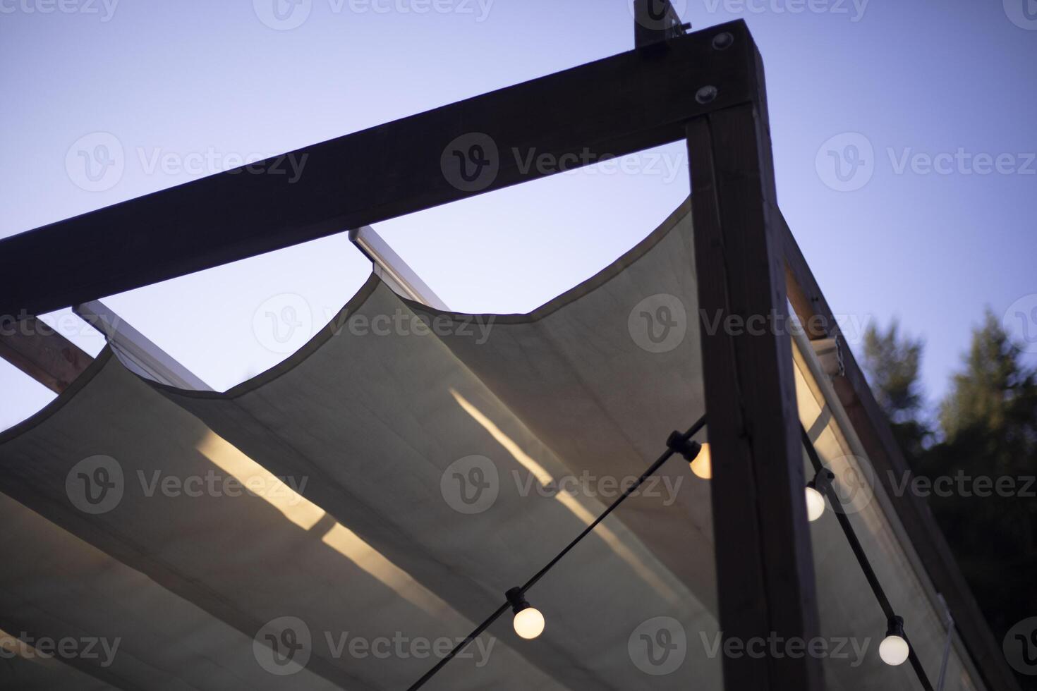 Fabric ceiling on the veranda. Lightweight construction of planks. Summer pergola. photo