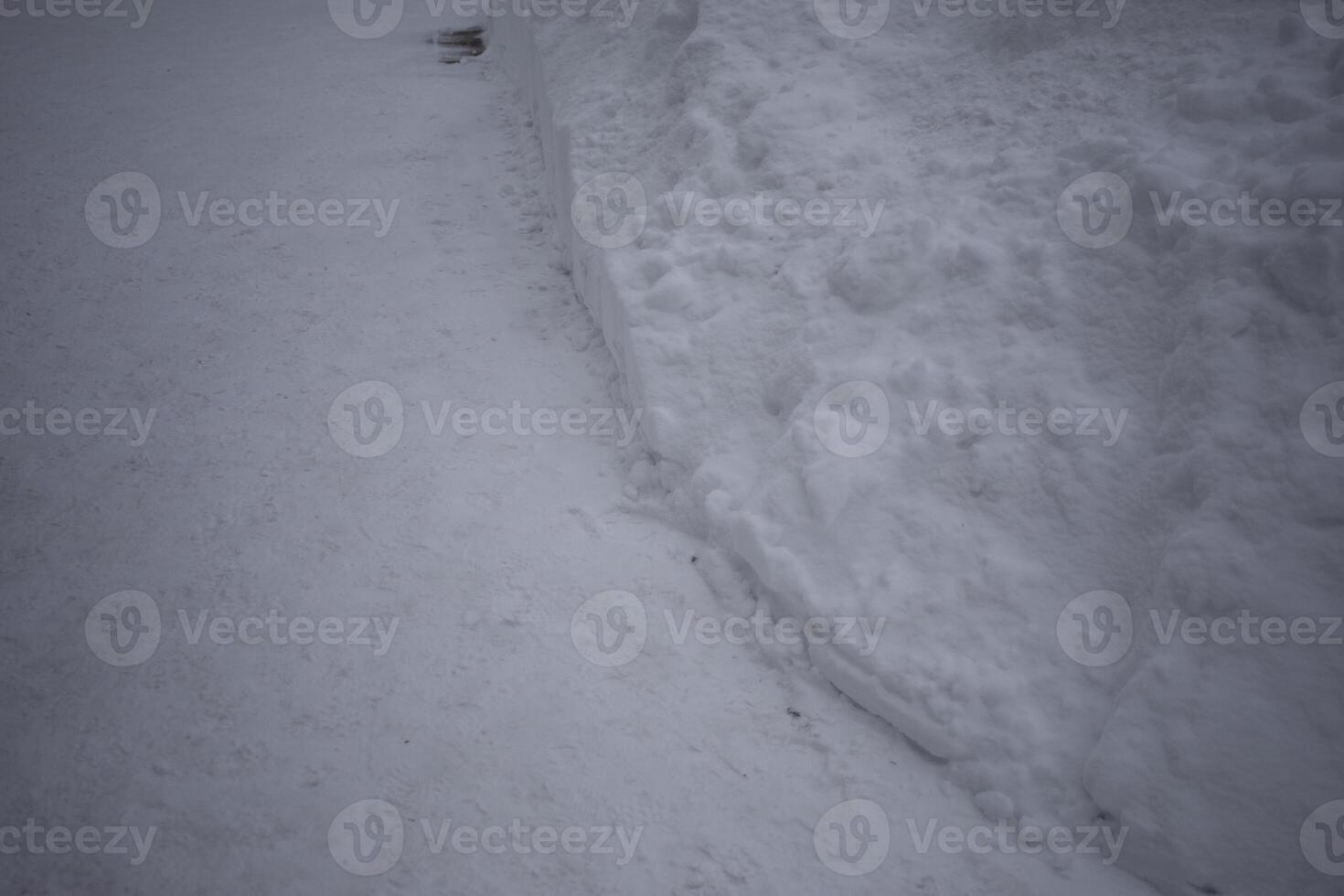 Cleared snow. A lot of snow on the road. A snowdrift on the street. photo