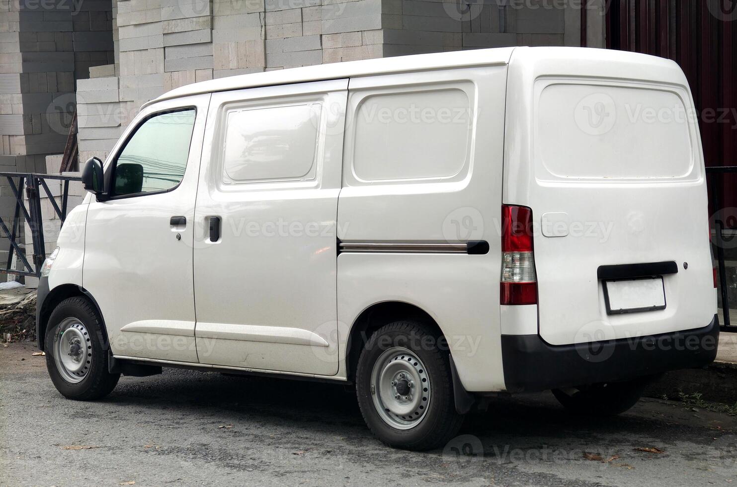 white minivan park in road. shipping transportation business. photo
