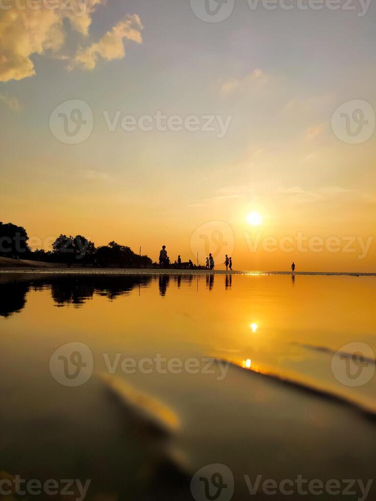 Children Playing at Sunset on the Beach photo