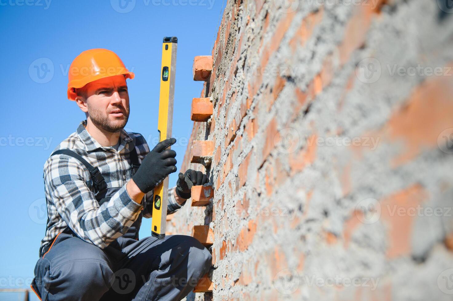 Portrait of a builder in the process of working on a construction site outdoors photo