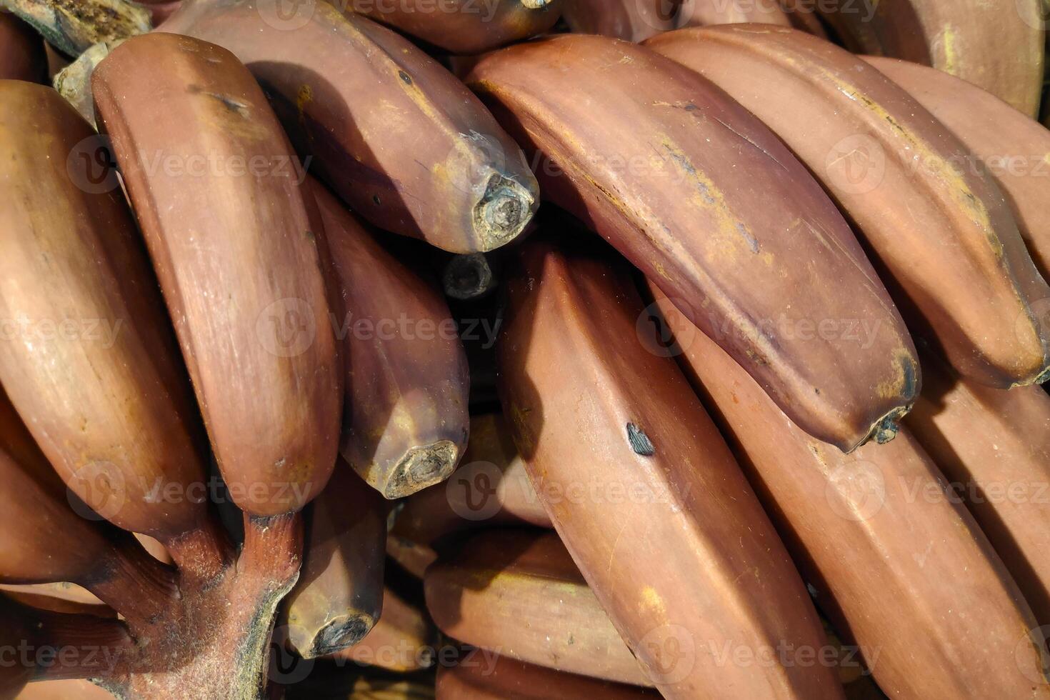 Stack of Red bananas on a market stall photo