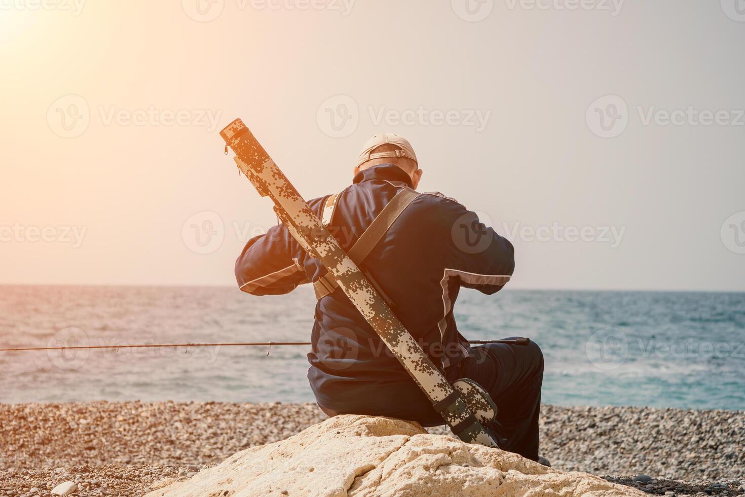 Man hobby fishing on sea tightens a fishing line reel of fish summer. Calm surface sea. Close-up of a fisherman hands twist reel with fishing line on a rod. Fishing in the sea outdoors. Slow motion. photo