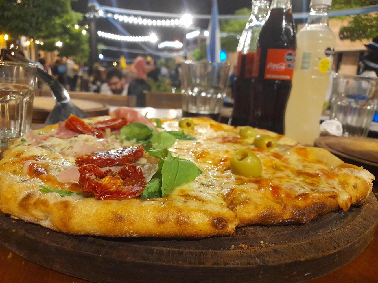 A pizza on a wooden table photo