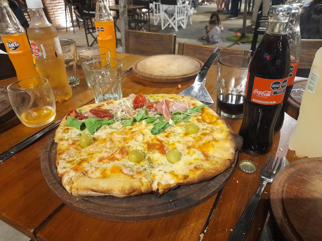 A pizza on a wooden table photo