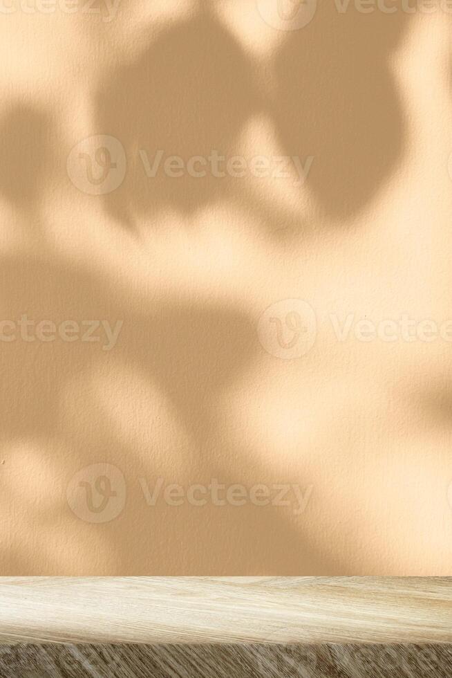 Minimal Wooden Table with Golden Straw Concrete Wall in Vertical Background with Leaves Shadow and Light Beam photo