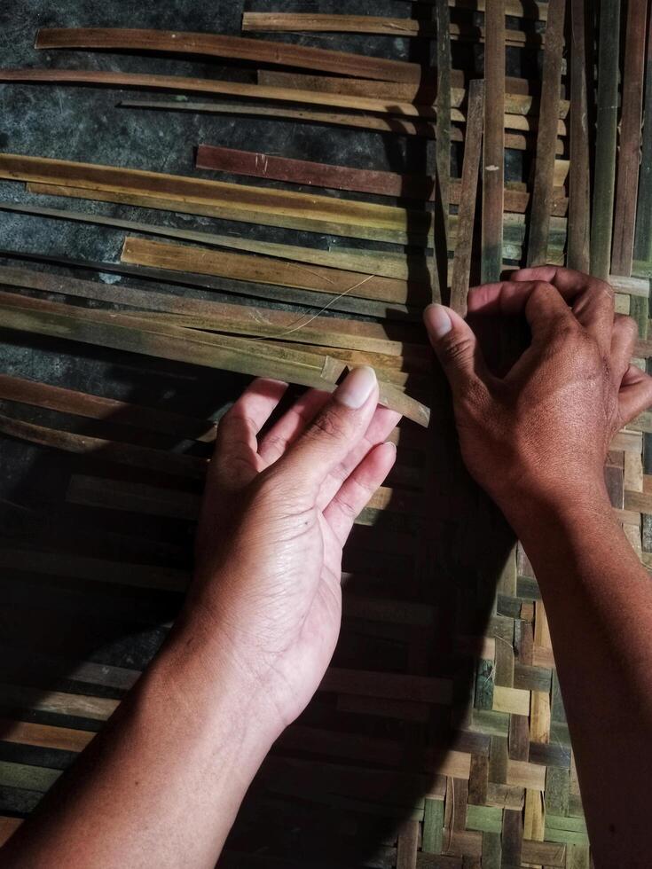Skilled Hands Weaving Bamboo Mat photo