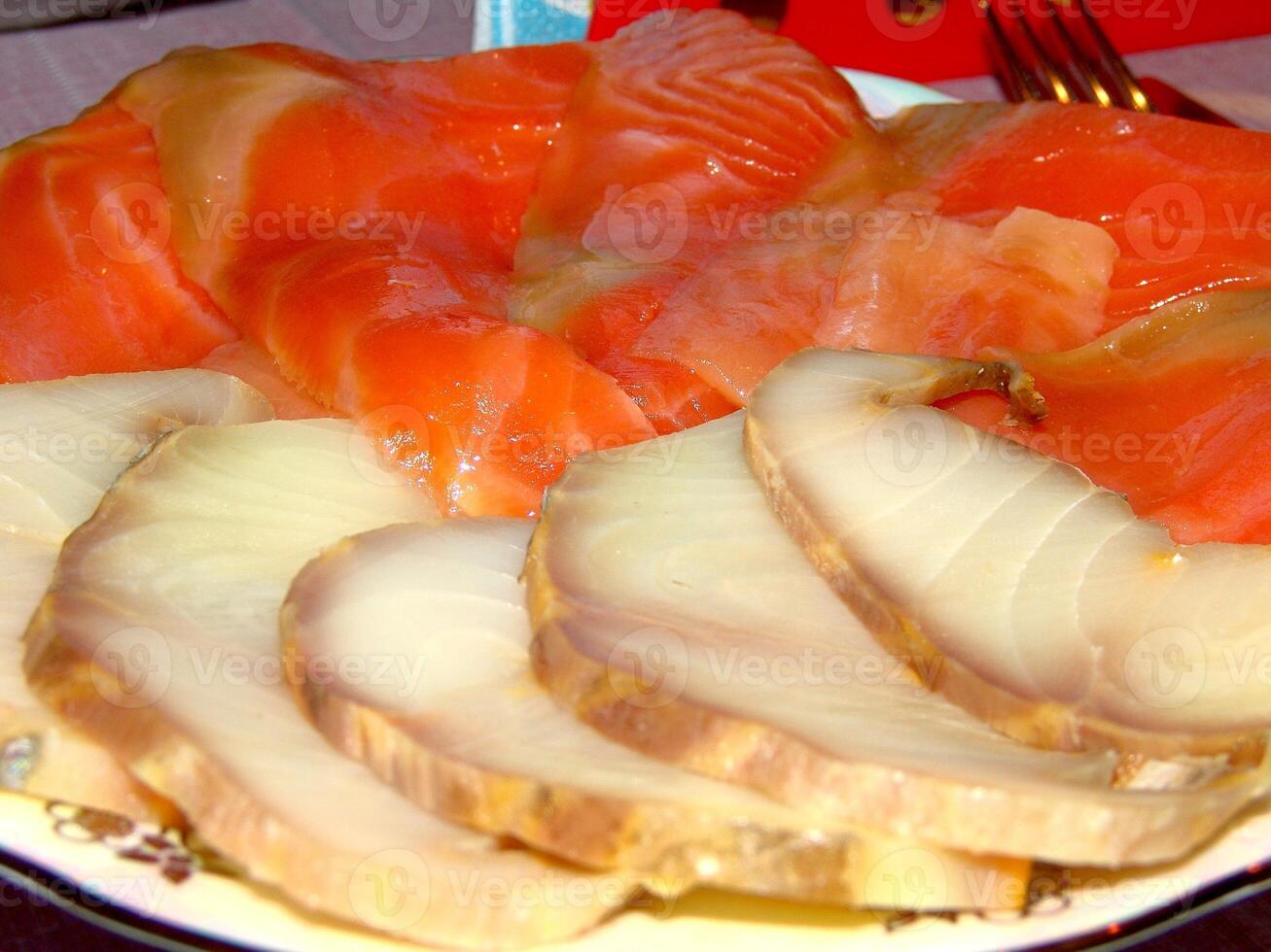 Red and white fish slices on a plate close view background photo