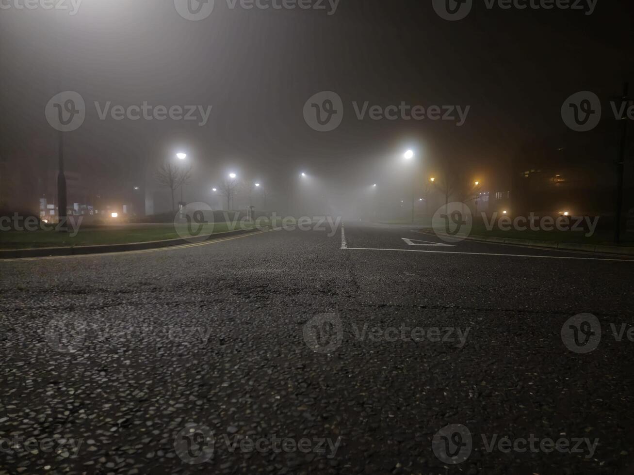 Night empty highway in mist and lamp posts lights photo