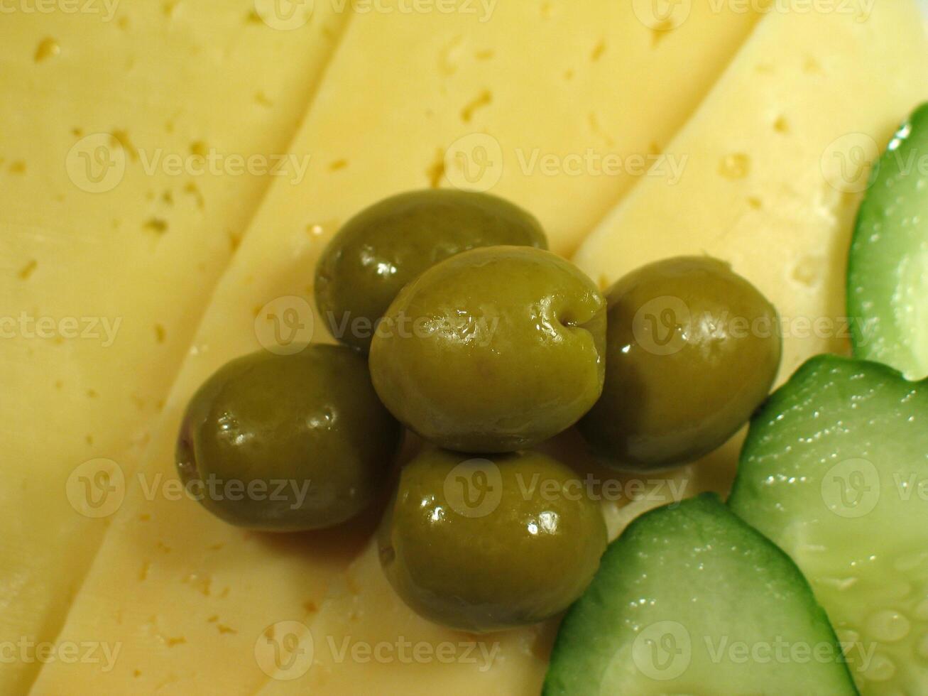 Green olives and cucumber close view background photo