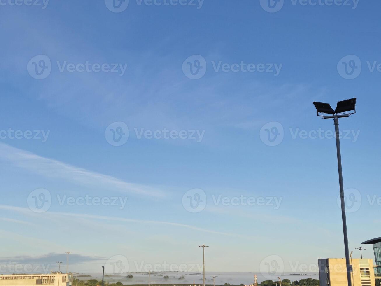 Cumulus Clouds Over a Street Road with Light Pole photo
