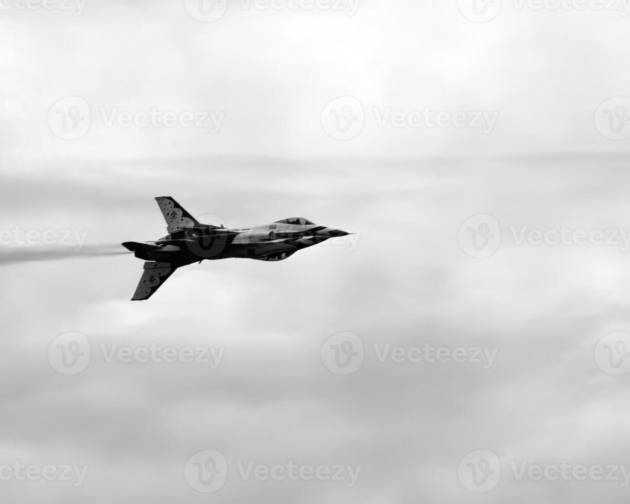 Airshow of military jet fighters. Group of military airplanes performs maneuvers with a smoke trace. Aviation background photo