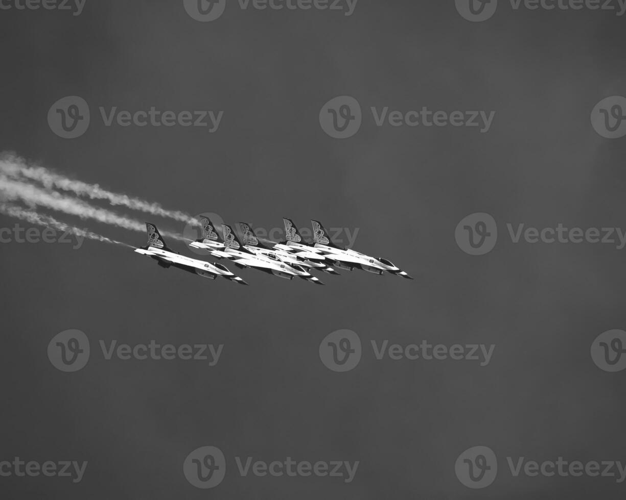 Airshow of military jet fighters. Group of military airplanes performs maneuvers with a smoke trace. Aviation background photo