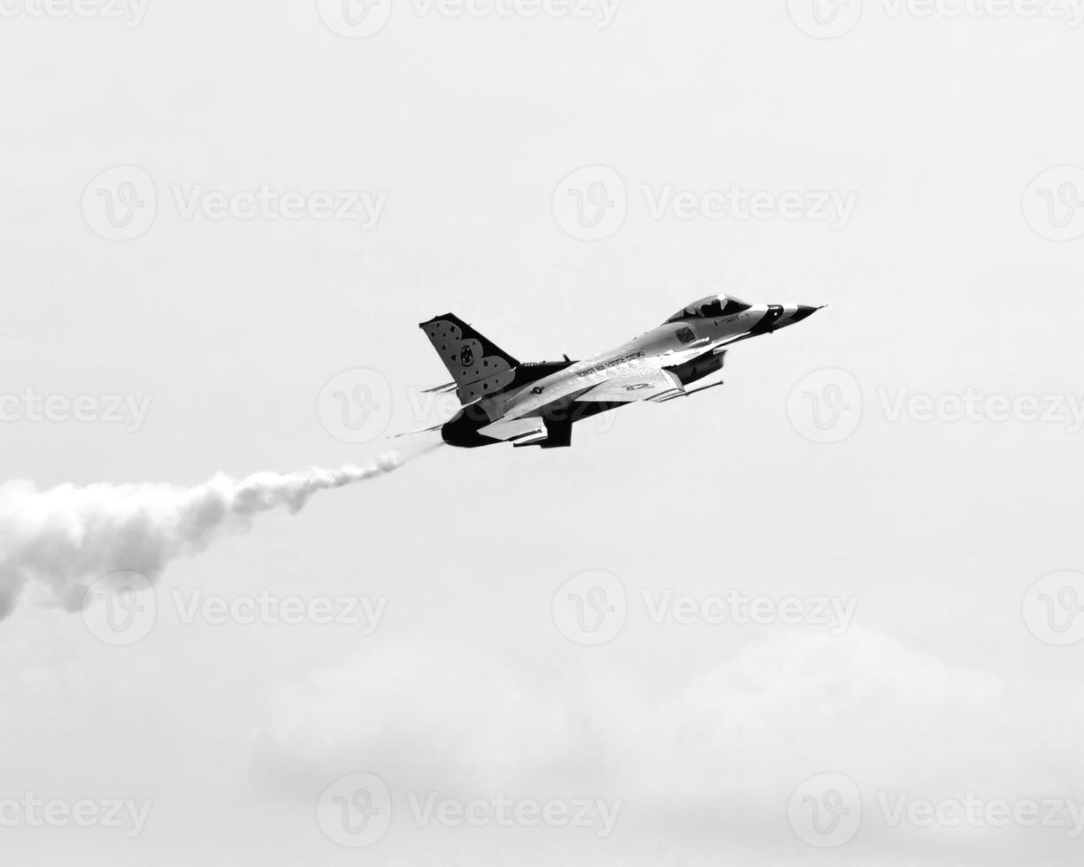 Airshow of military jet fighters. Group of military airplanes performs maneuvers with a smoke trace. Aviation background photo