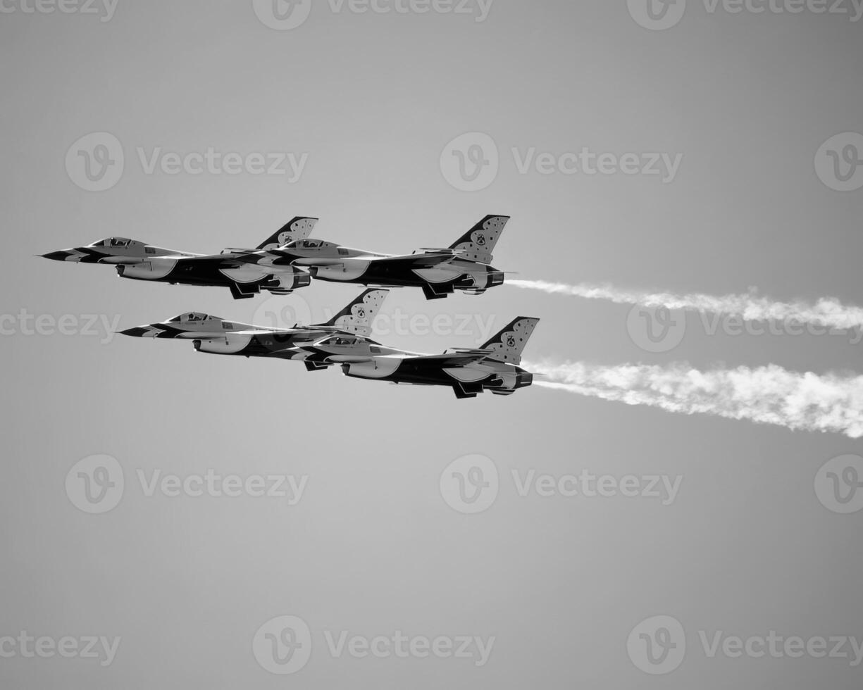 Airshow of military jet fighters. Group of military airplanes performs maneuvers with a smoke trace. Aviation background photo