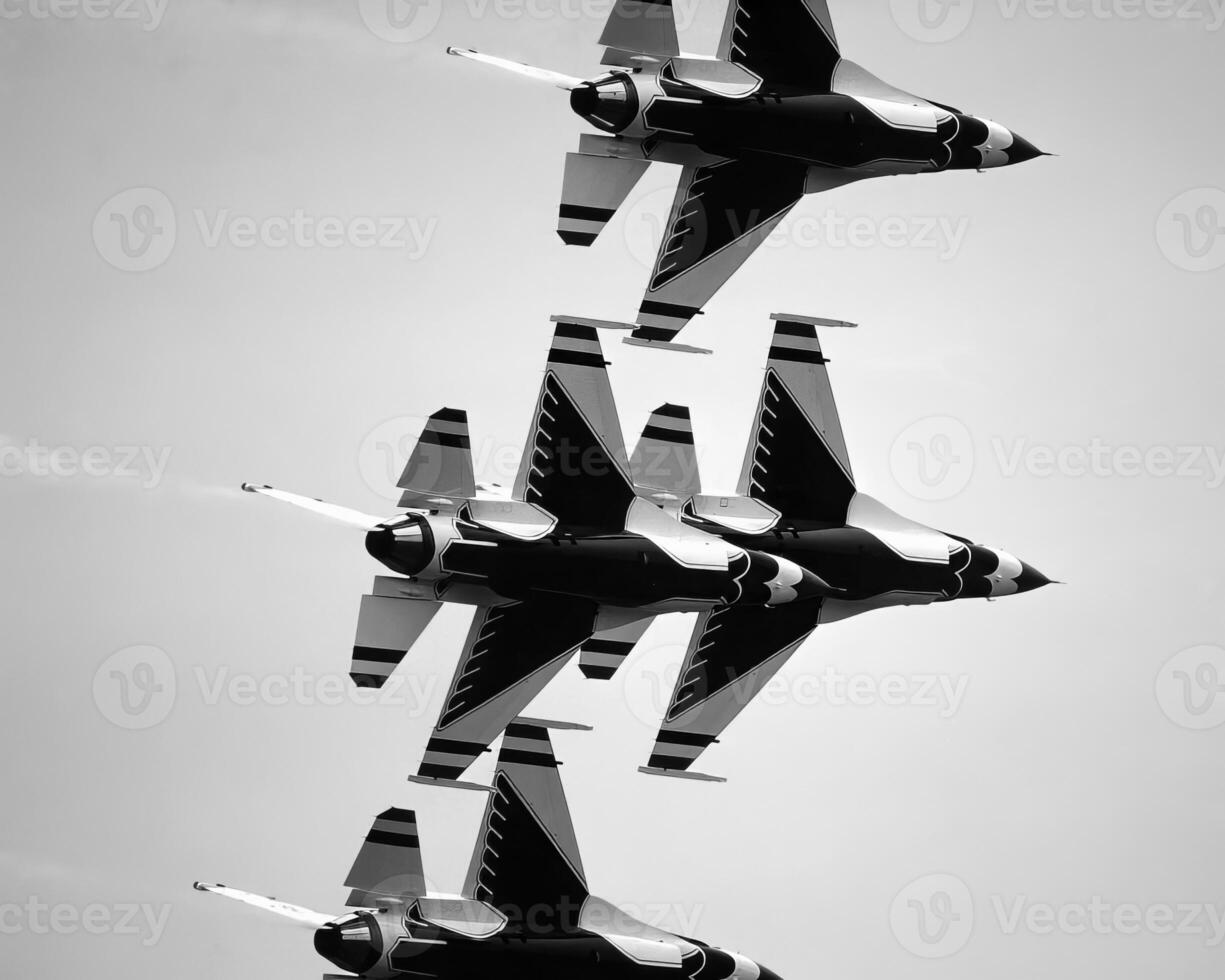 Airshow of military jet fighters. Group of military airplanes performs maneuvers with a smoke trace. Aviation background photo